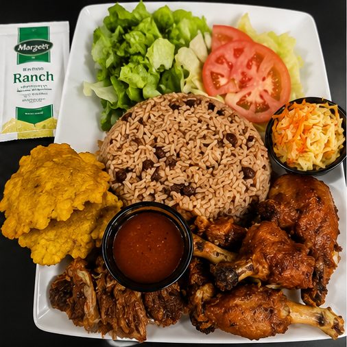Fried chicken plate with rice, beans, and fried plantains at 509 Restaurant and Lounge